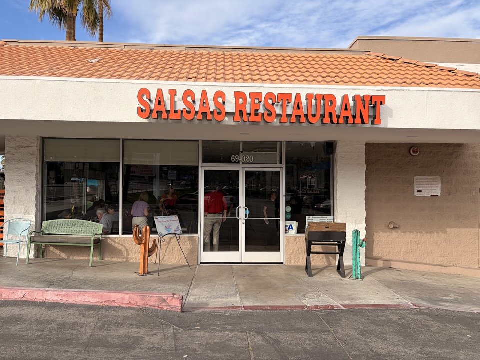 Restaurant exterior in a strip-mall setting.